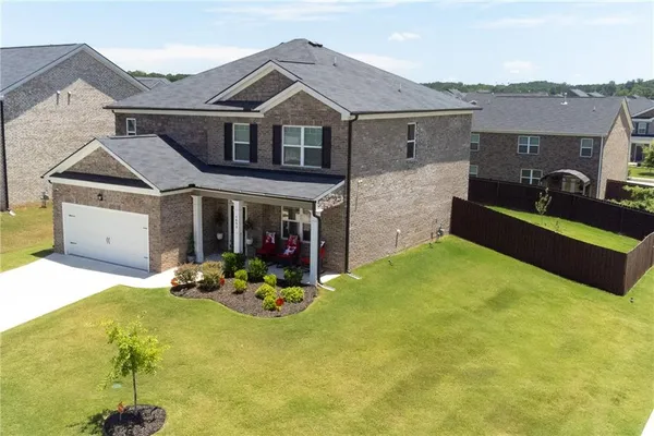 a front view of a house with yard and patio