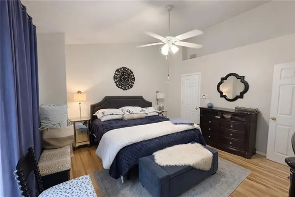 a bedroom with a bed and a chandelier