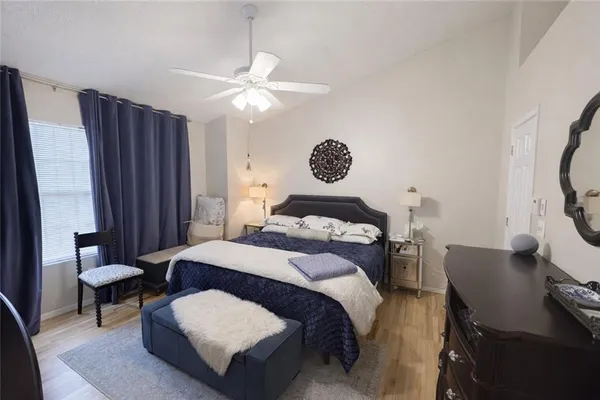 a bedroom with a bed and a chandelier