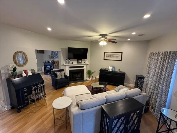 a living room with furniture a fireplace and a flat screen tv