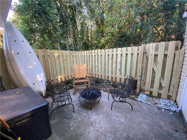 a backyard of a house with table and chairs