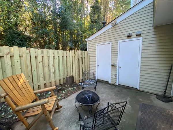 a view of a chairs and table in patio