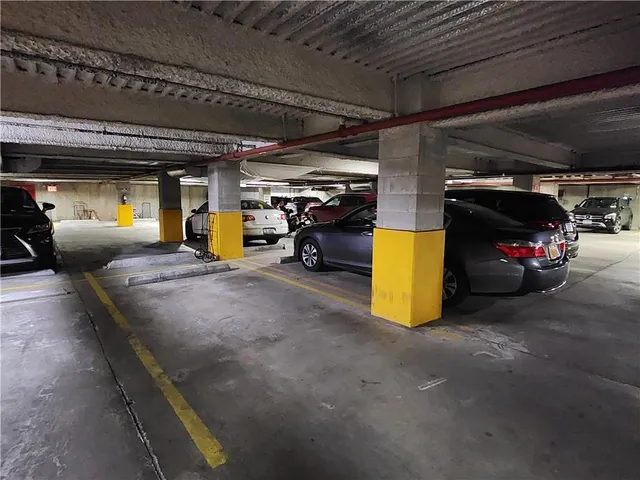 a view of parking garage with cars