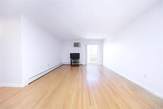 a view of an empty room and wooden floor