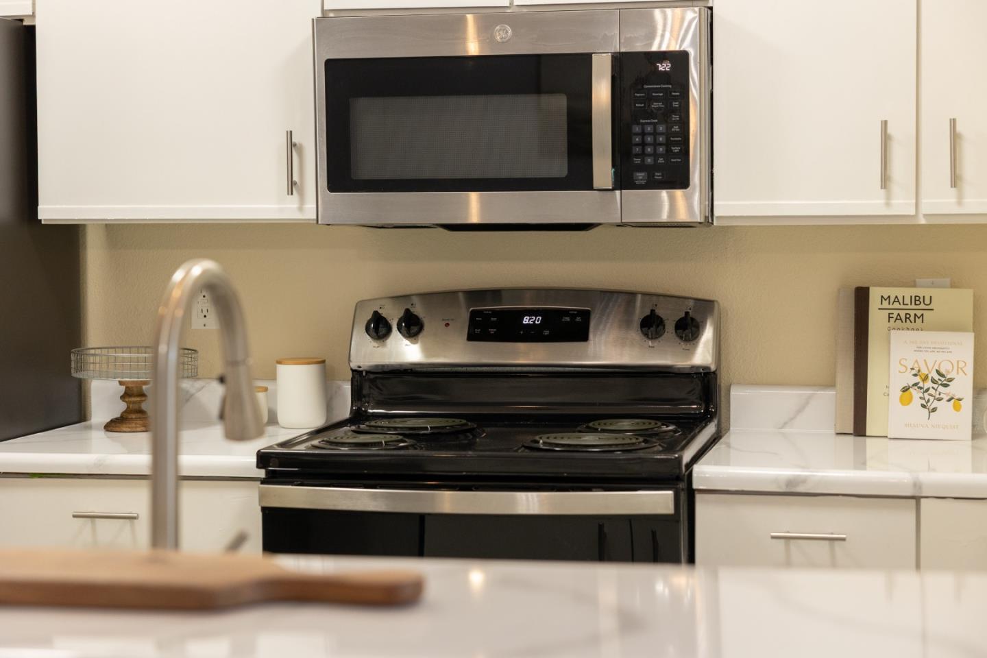 1644 Ocean Street Santa Cruz, CA 95060 - Photo 16 of 60 a kitchen with stainless steel appliances granite countertop a stove and a microwave