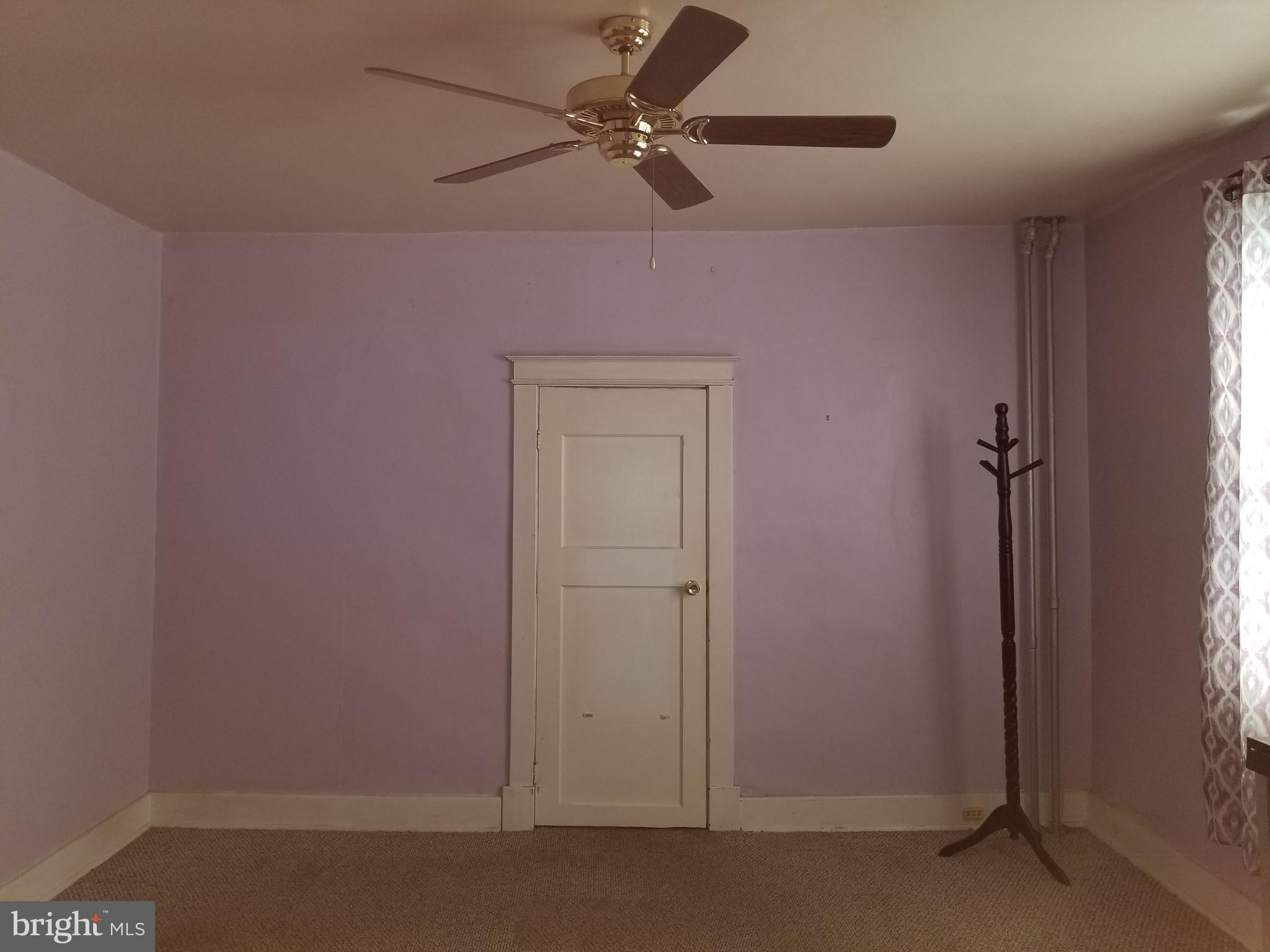 1115 Rosedale Avenue Baltimore, MD 21237 - Photo 13 of 27 an empty room with a window and a fan