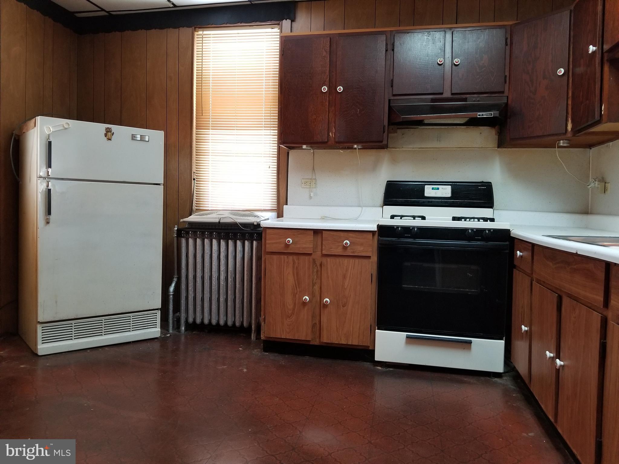1115 Rosedale Avenue Baltimore, MD 21237 - Photo 15 of 27 a kitchen with a stove and a refrigerator