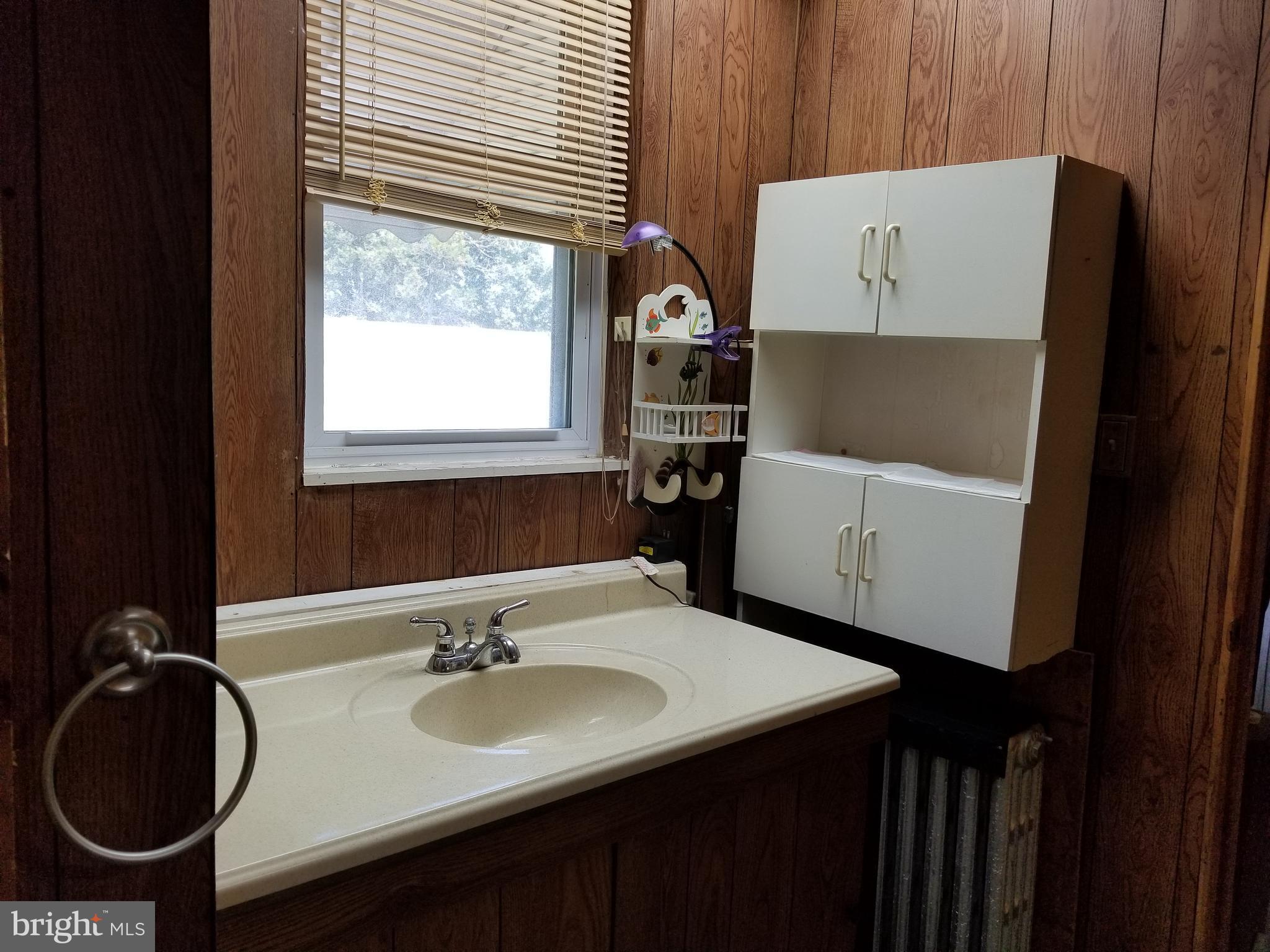1115 Rosedale Avenue Baltimore, MD 21237 - Photo 17 of 27 a bathroom with a sink and a vanity