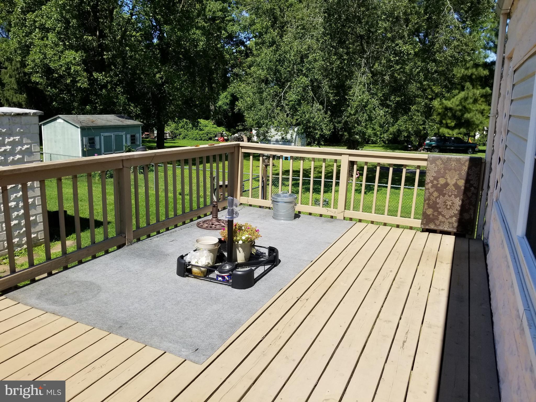 1115 Rosedale Avenue Baltimore, MD 21237 - Photo 24 of 27 a balcony with wooden floor and fence