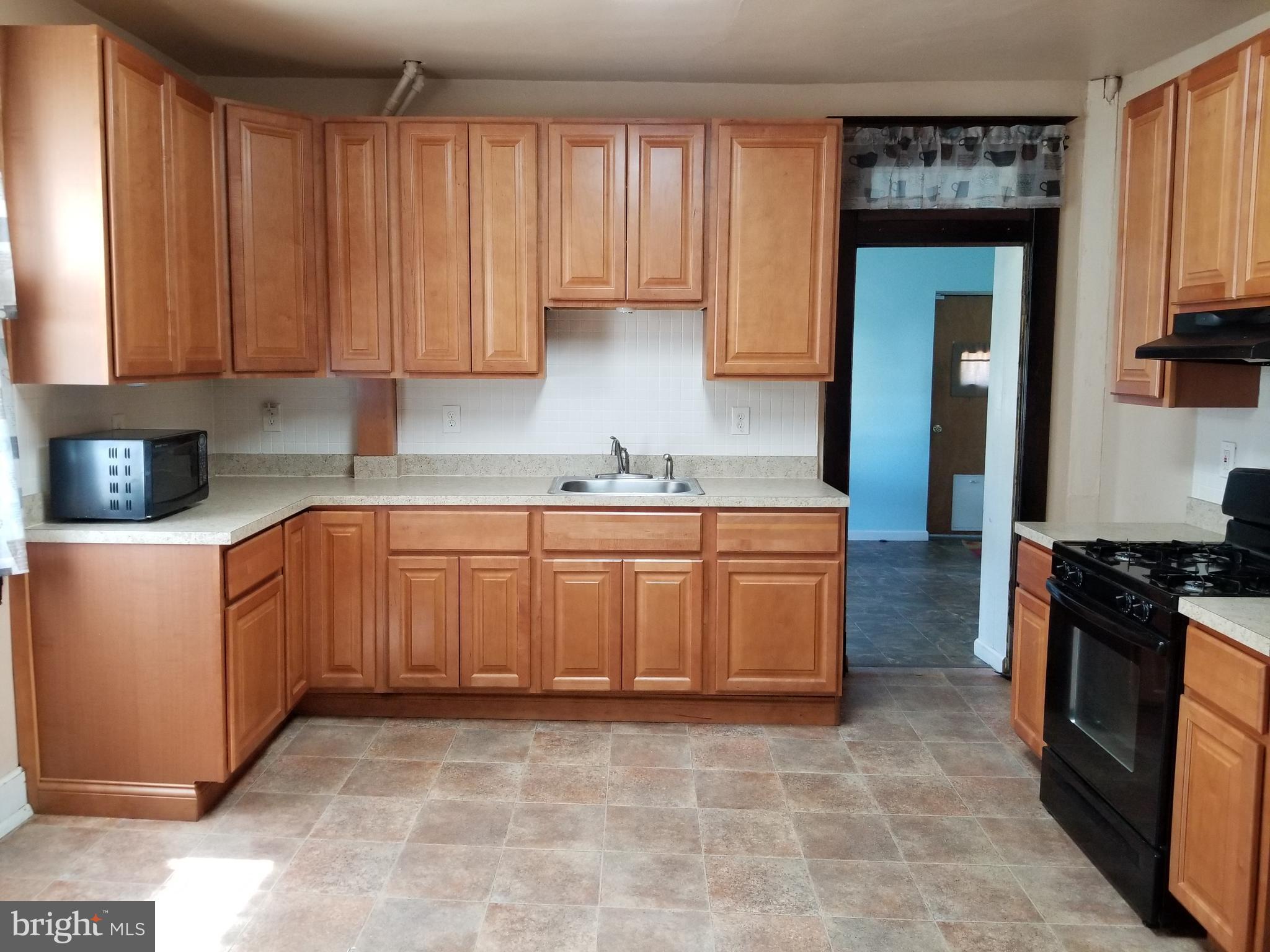 1115 Rosedale Avenue Baltimore, MD 21237 - Photo 4 of 27 a kitchen with stainless steel appliances granite countertop a stove a sink and a refrigerator