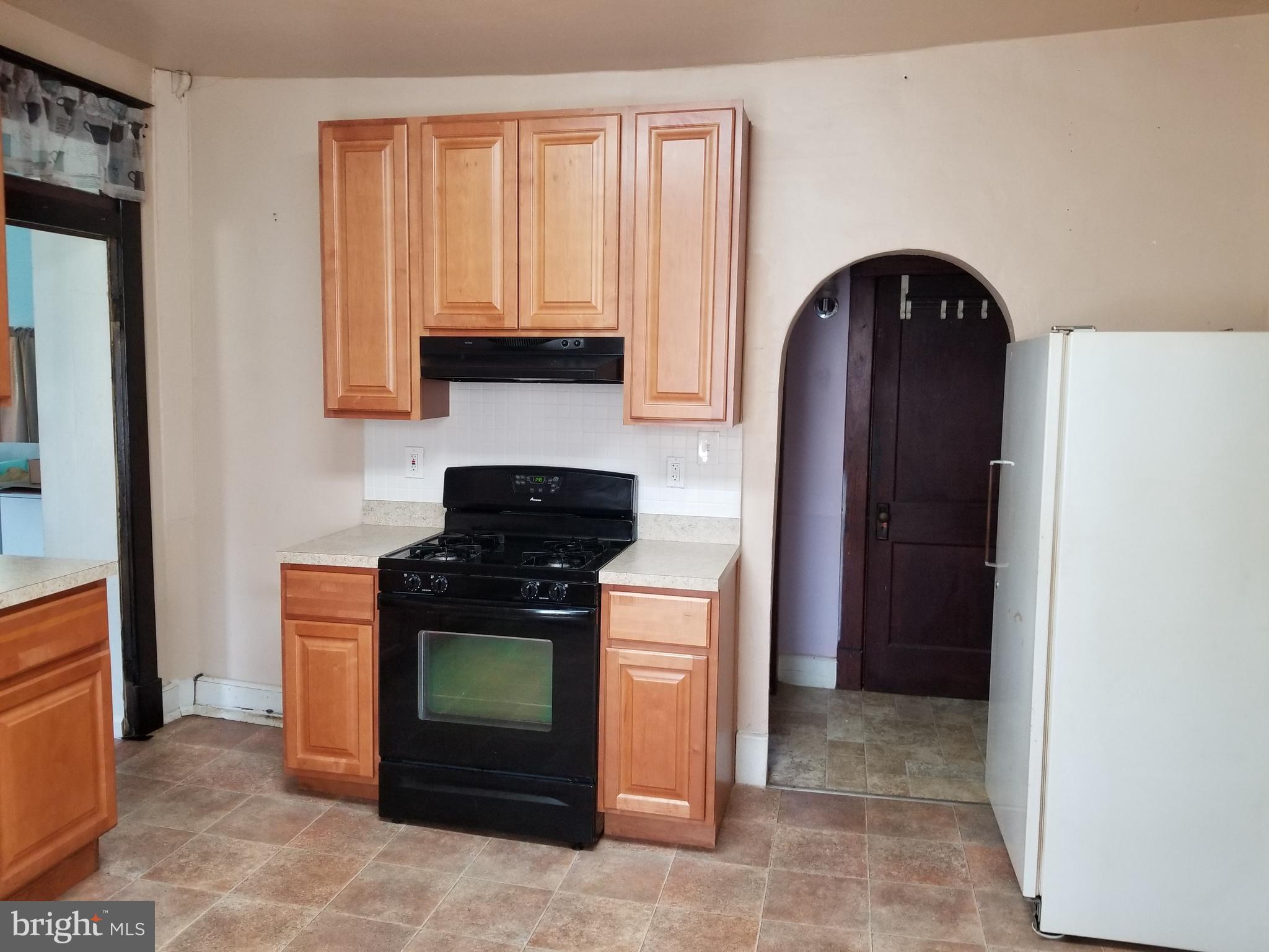 1115 Rosedale Avenue Baltimore, MD 21237 - Photo 7 of 27 a kitchen with a stove and a refrigerator