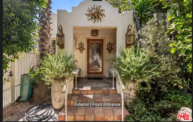 a front view of a house with a garden