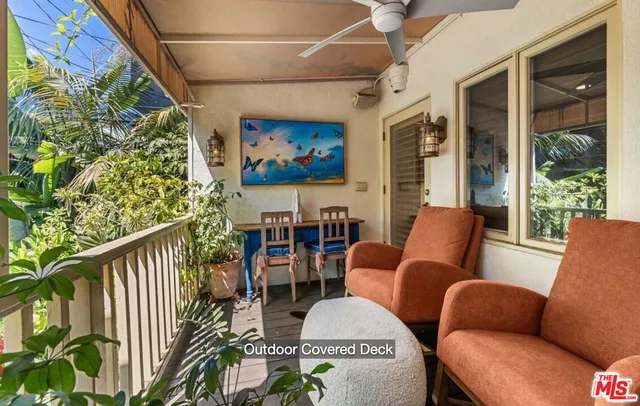 a outdoor living room with furniture and a potted plant