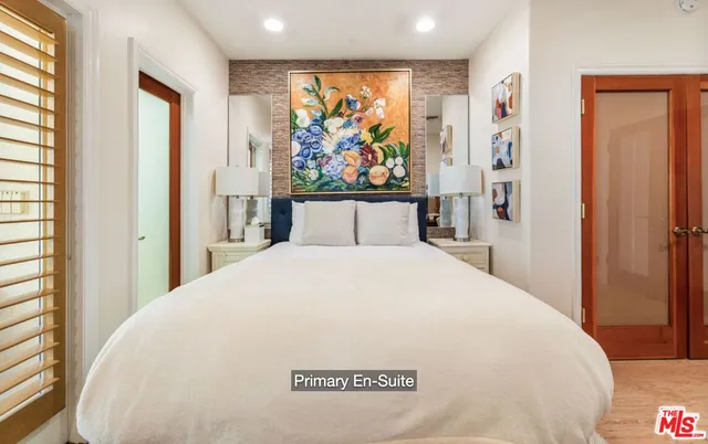 a bedroom with a large bed and a window