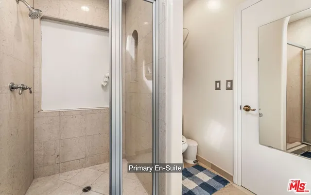 a bathroom with a shower and a sink