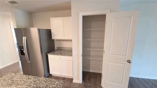a kitchen with a refrigerator and cabinets