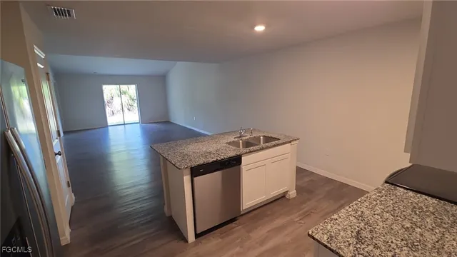 an entryway and livingroom with wooden floor