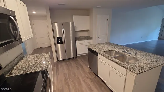 a kitchen with a sink stove and refrigerator