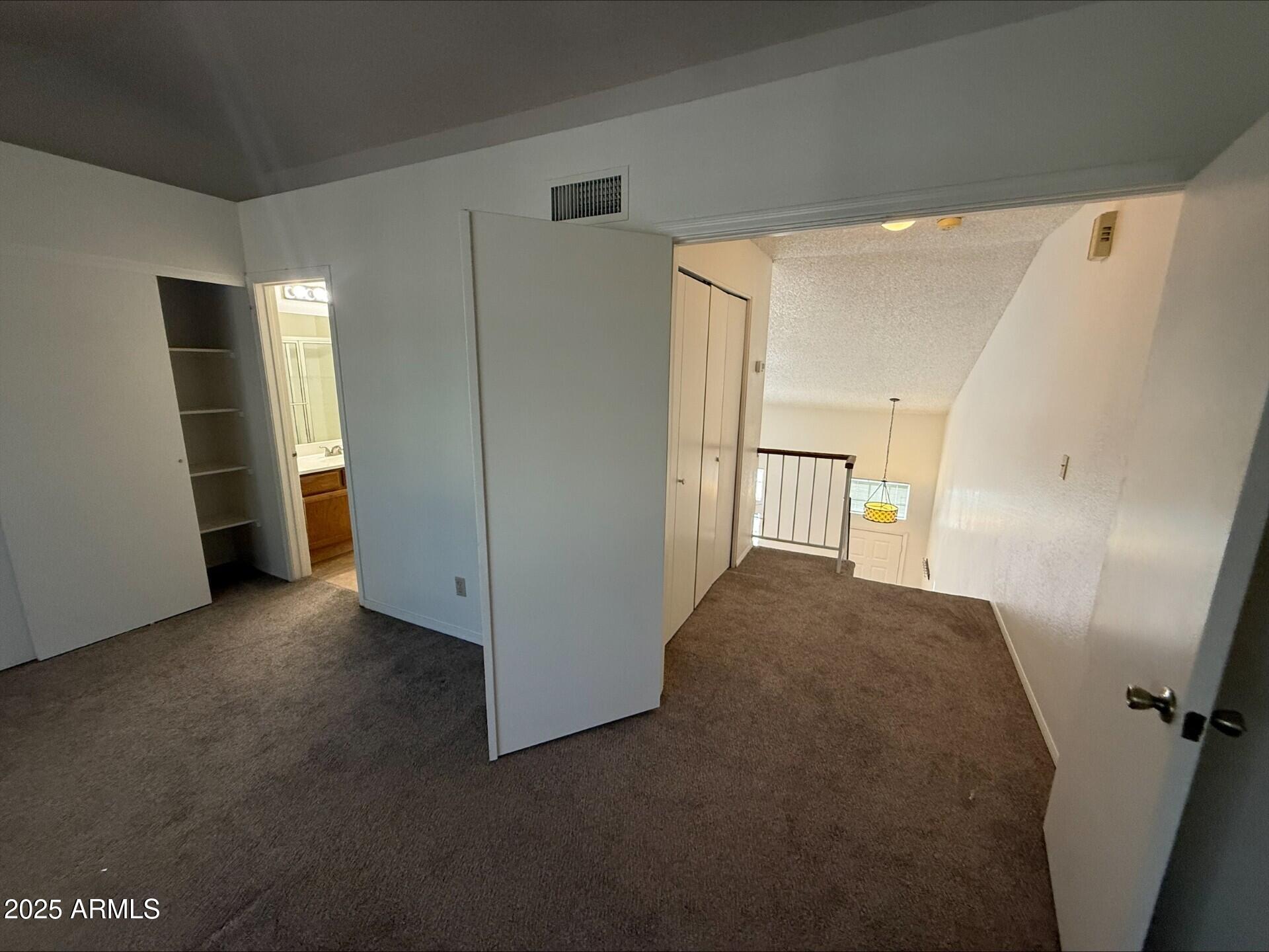 3930 West Monterey Street, Unit 113 Chandler, AZ 85226 - Photo 14 of 20 a view of hallway with furniture and a refrigerator