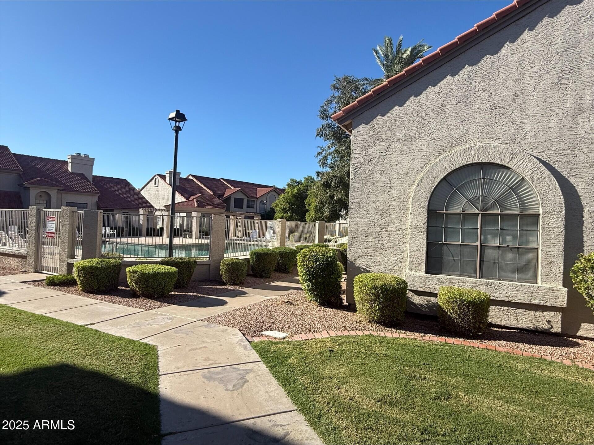 3930 West Monterey Street, Unit 113 Chandler, AZ 85226 - Photo 17 of 20 a front view of a house with a garden