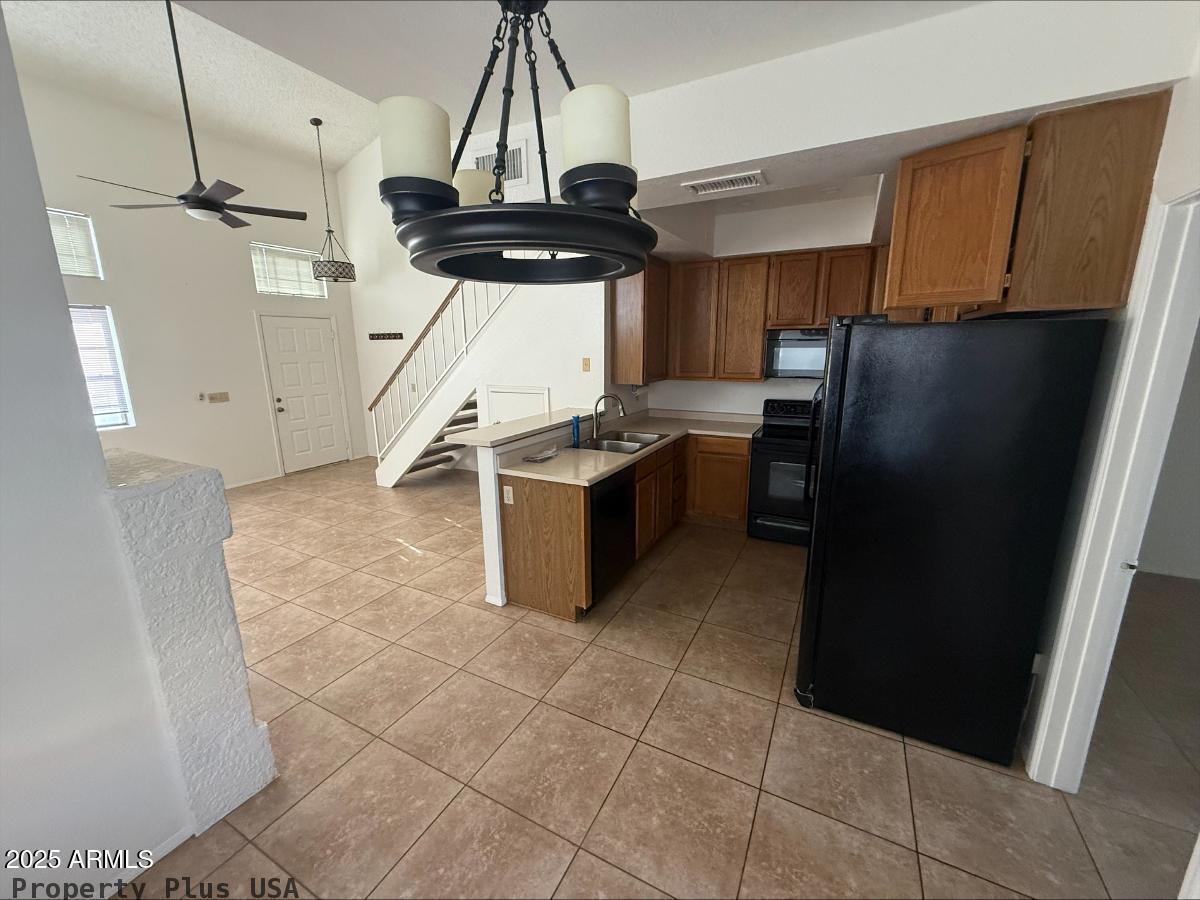 3930 West Monterey Street, Unit 113 Chandler, AZ 85226 - Photo 5 of 20 a kitchen with stainless steel appliances granite countertop a refrigerator a stove and a sink