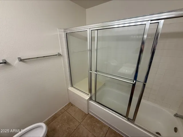 a bathroom with a glass shower door