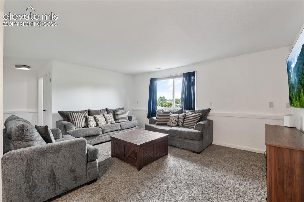 125 Diamond E Road Fountain, CO 80817 - Photo 23 of 43 a living room with furniture and a large window