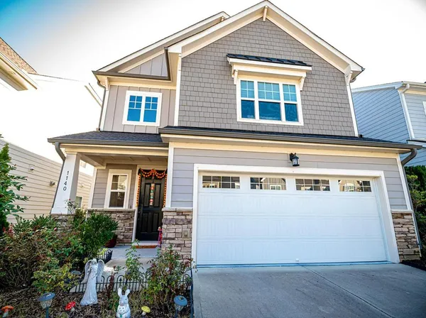 a front view of a house with a yard and garage