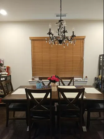 a view of a dining room with furniture and window