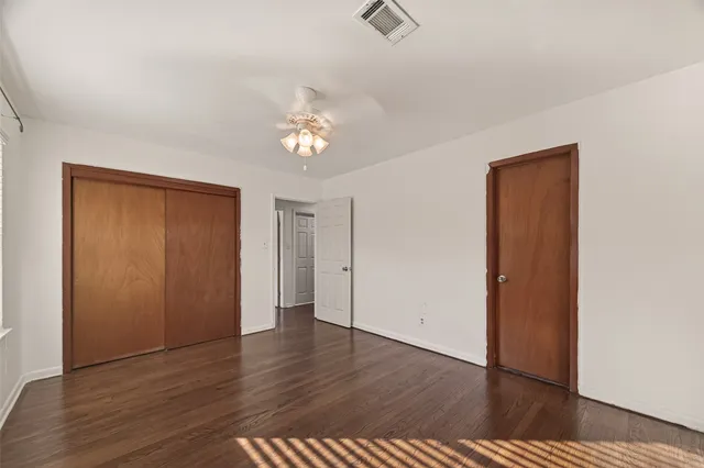 a view of a patio with table and chairs potted plants with floor to ceiling window