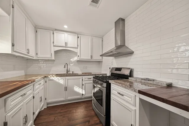 an empty room with wooden floor and a ceiling fan