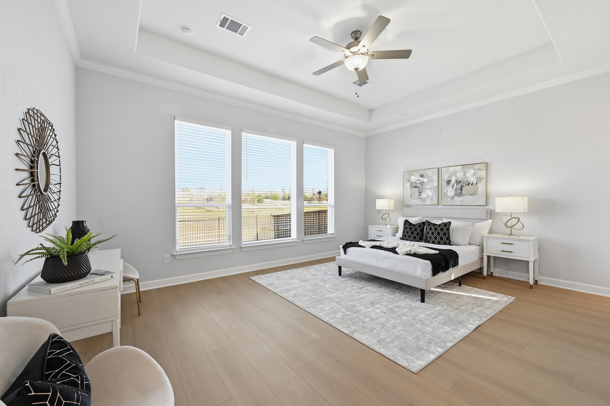 176 Wild Pecan Loop Buda, TX 78610 - Photo 13 of 30 Bedroom with a ceiling fan, light wood finished floors, ornamental molding, and a tray ceiling
