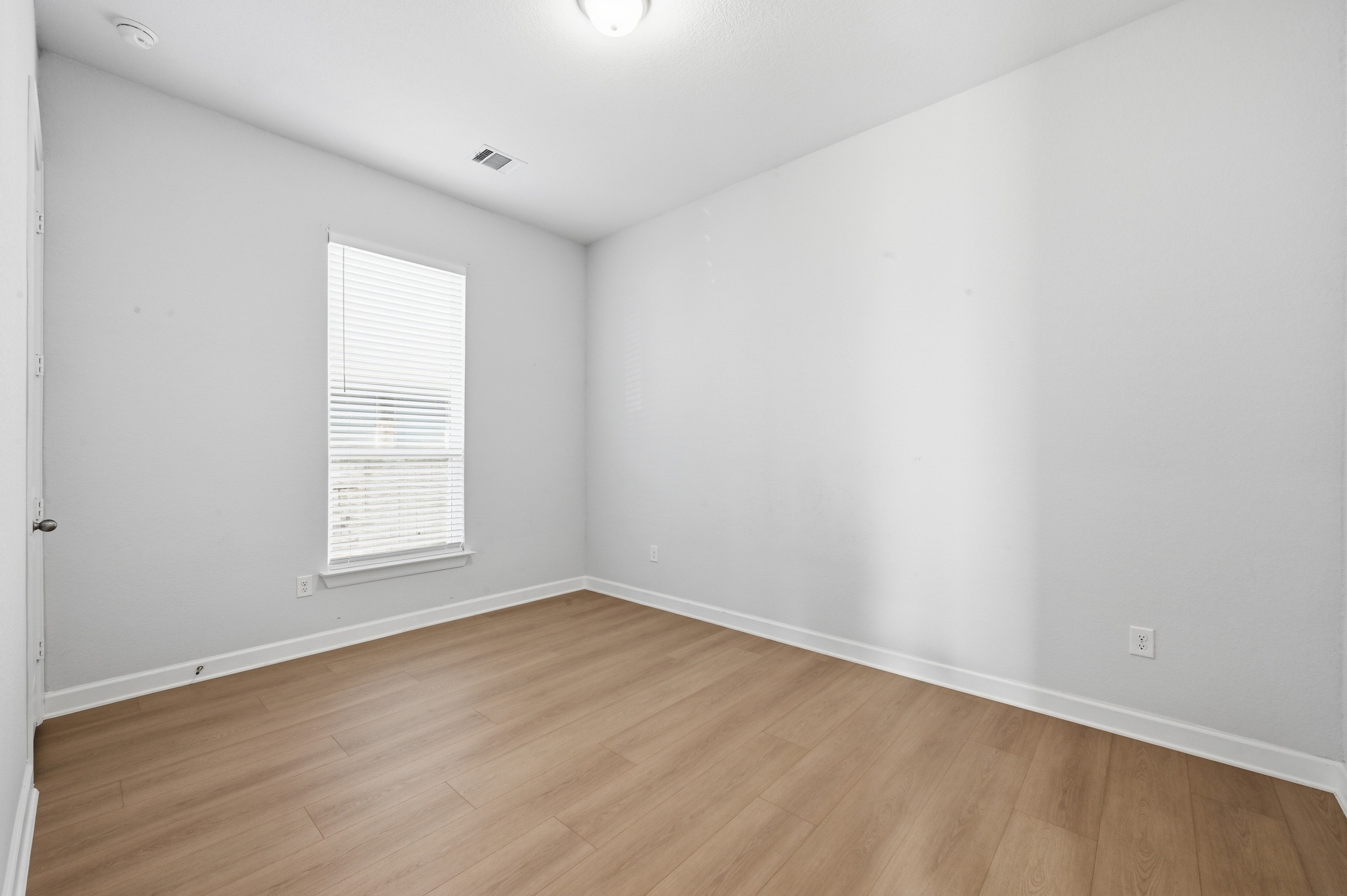 176 Wild Pecan Loop Buda, TX 78610 - Photo 17 of 30 Unfurnished room with baseboards and light wood-style floors