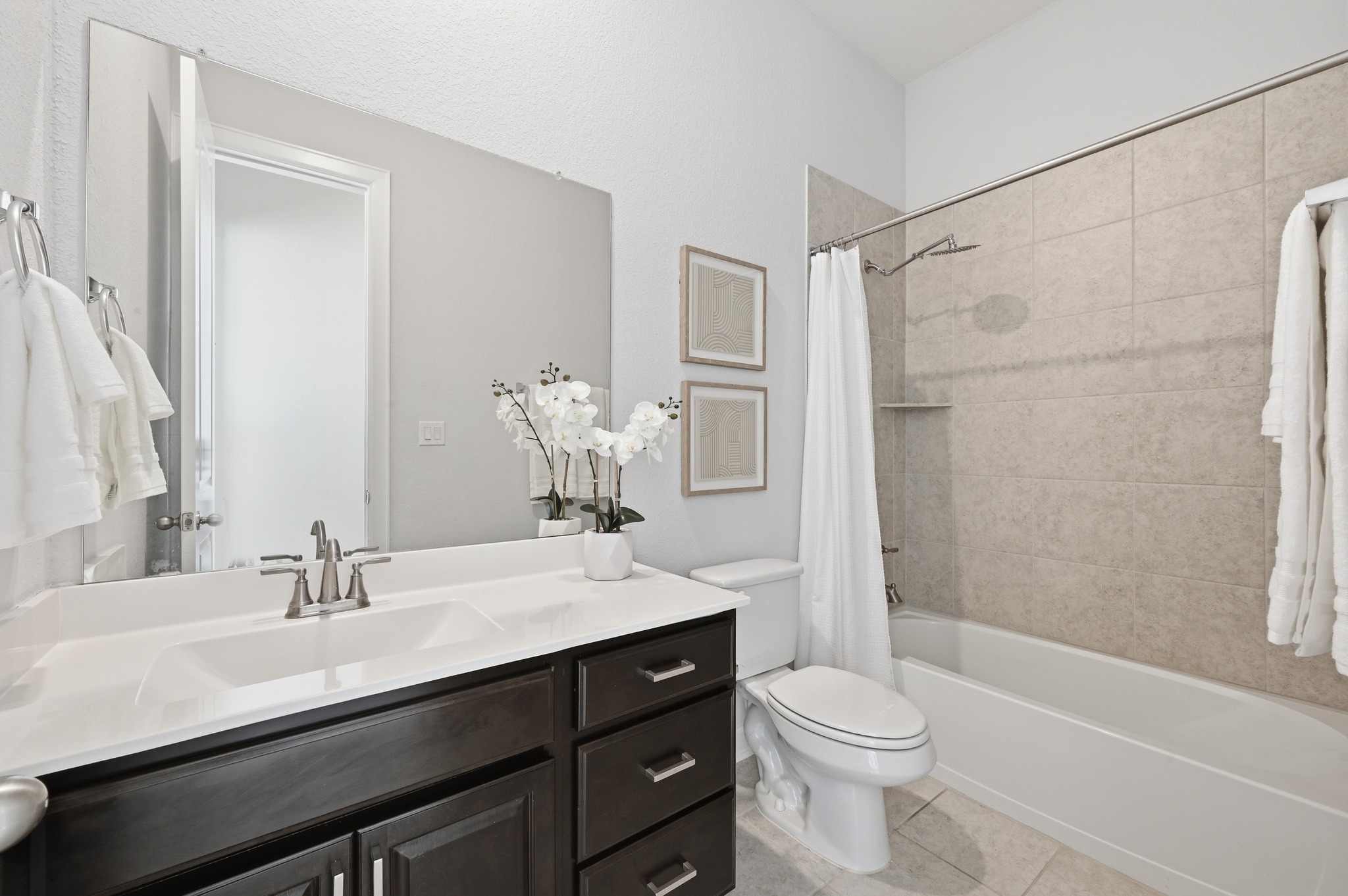 176 Wild Pecan Loop Buda, TX 78610 - Photo 18 of 30 Bathroom featuring vanity, shower / bathtub combination with curtain, and light tile patterned floors