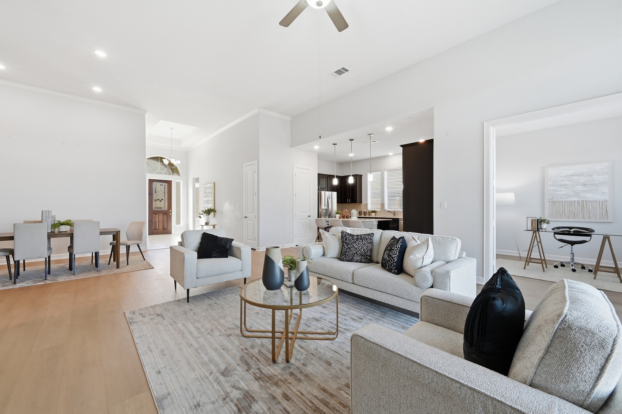 176 Wild Pecan Loop Buda, TX 78610 - Photo 2 of 30 Living room with ceiling fan, recessed lighting, and light wood-style floors
