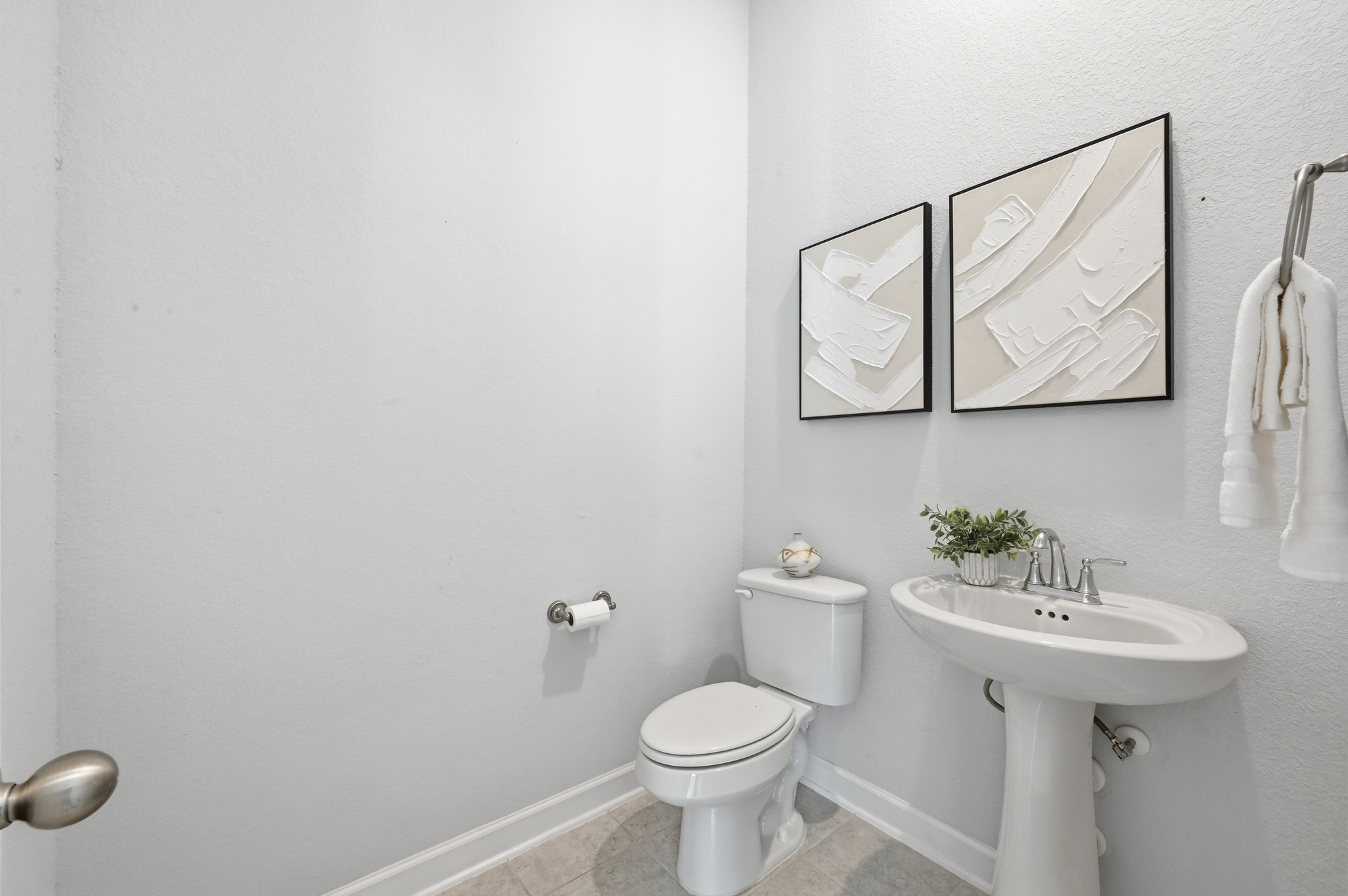 176 Wild Pecan Loop Buda, TX 78610 - Photo 19 of 30 Half bath with toilet and light tile patterned flooring