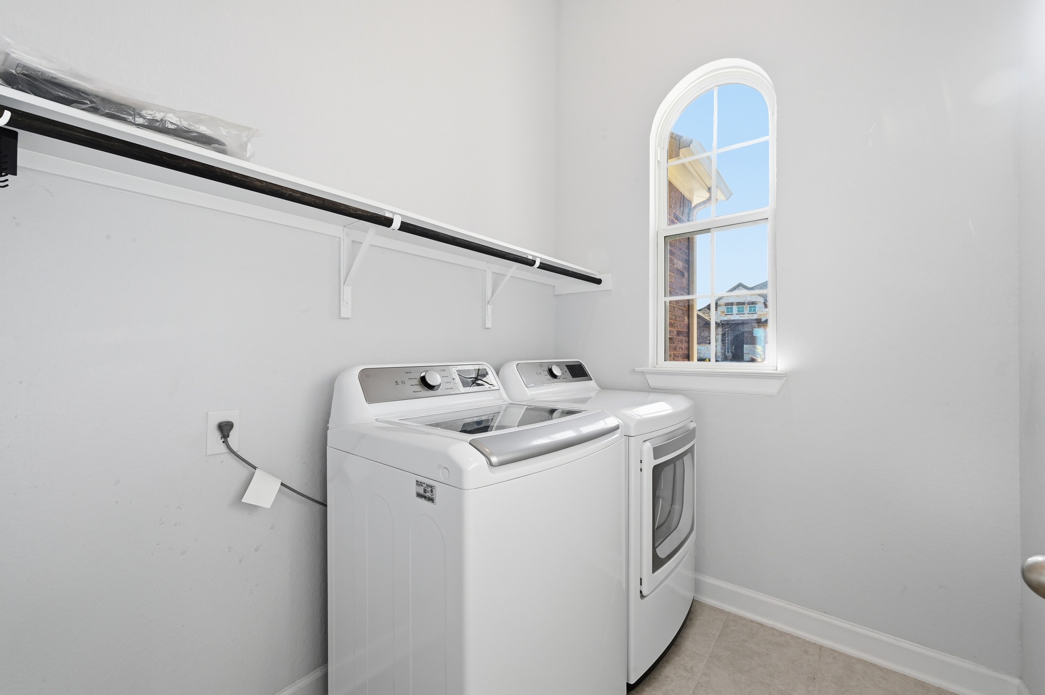176 Wild Pecan Loop Buda, TX 78610 - Photo 21 of 30 Laundry room featuring separate washer and dryer and light tile patterned floors