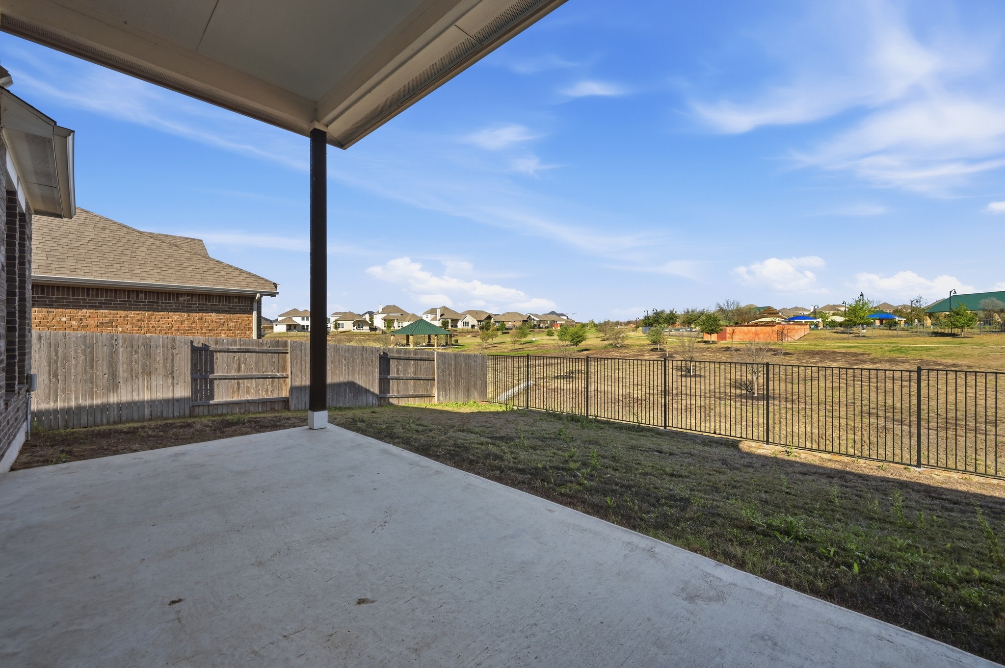 176 Wild Pecan Loop Buda, TX 78610 - Photo 22 of 30 Fenced backyard with a residential view and a patio