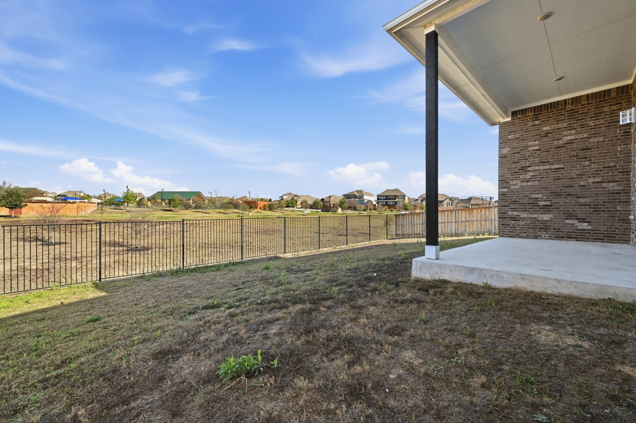 176 Wild Pecan Loop Buda, TX 78610 - Photo 23 of 30 Fenced backyard featuring a residential view and a patio