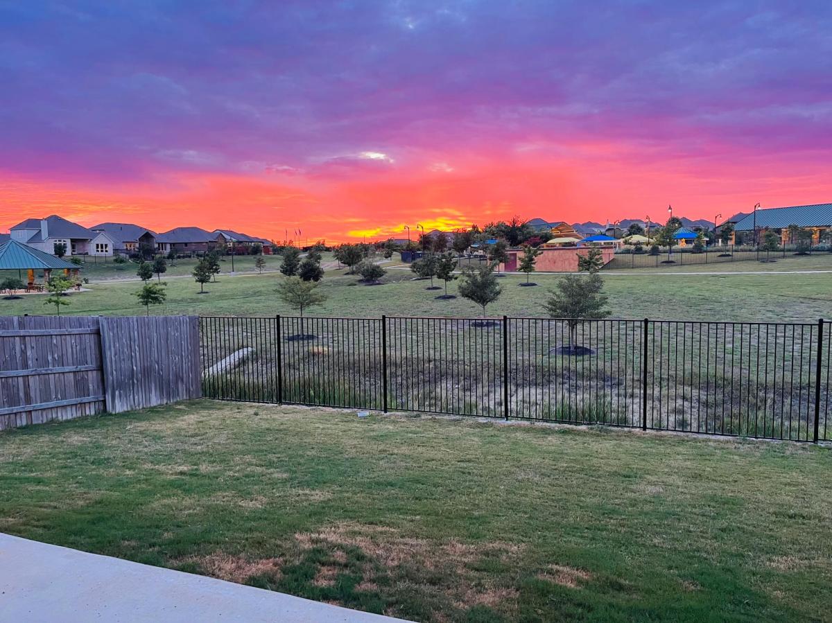176 Wild Pecan Loop Buda, TX 78610 - Photo 26 of 30 Yard at dusk featuring a residential view