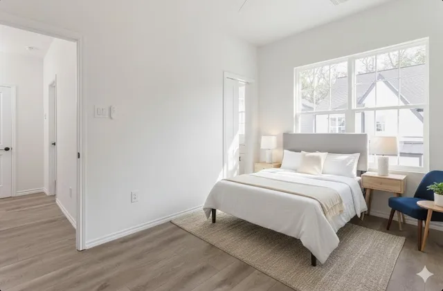 a bedroom with a bed and a large window