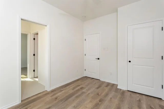 wooden floor with white cabinet
