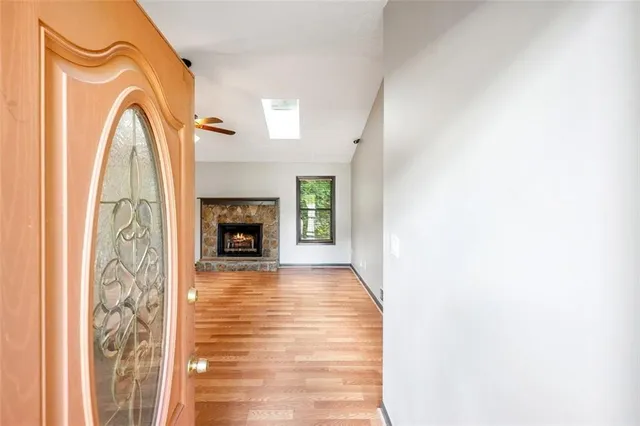 a view of a livingroom with wooden floor and a fireplace