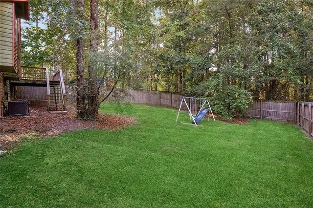 a view of a backyard with a garden and entertaining space