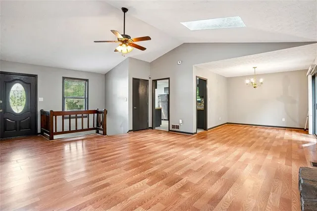 a view of a livingroom with a hardwood floor and a ceiling fan