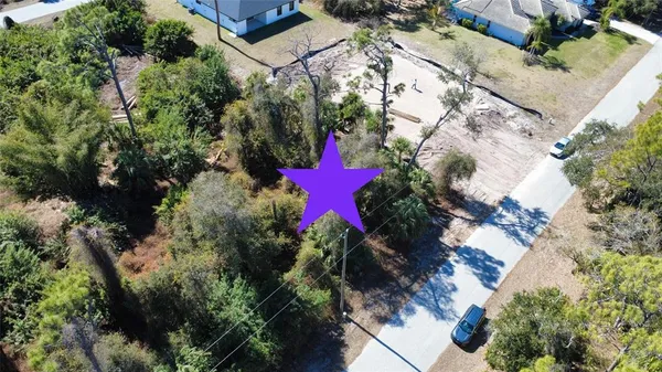an aerial view of a house with a yard
