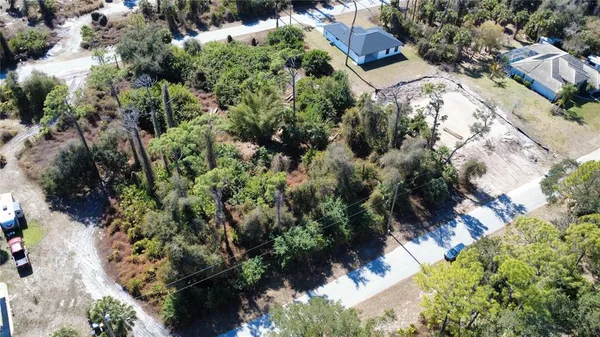 an aerial view of a house with a yard and garden space