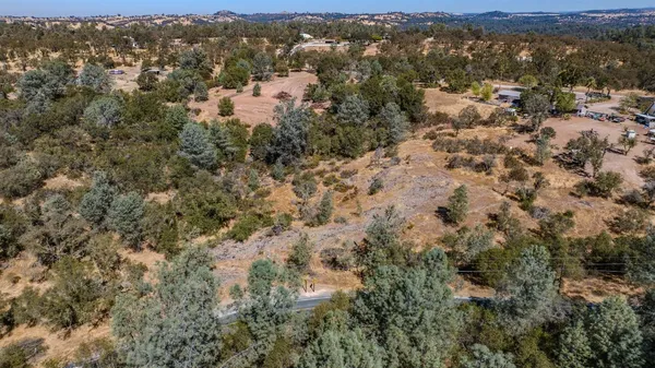 an aerial view of house with yard and mountain view