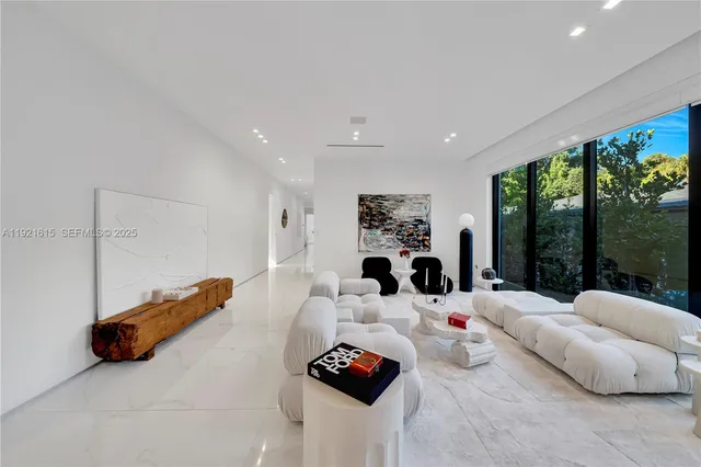 a kitchen with counter top space and living room view