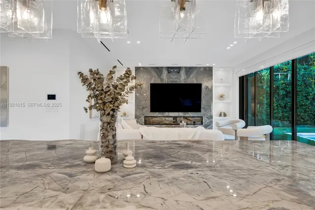 a bedroom with a large bed and a chandelier